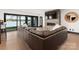 Spacious living room with lake views, stone fireplace, and comfortable leather seating at 180 Willow Point Rd, Troutman, NC 28166