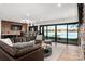 Open-concept living area with lake views, bar, and modern decor, perfect for entertaining at 180 Willow Point Rd, Troutman, NC 28166