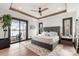 Luxurious main bedroom with lake views, tray ceiling, and modern decor at 180 Willow Point Rd, Troutman, NC 28166