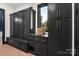 The mudroom features black cabinets and drawers for storage along with a view from the window at 180 Willow Point Rd, Troutman, NC 28166