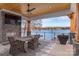 Outdoor patio with dining area, stone fireplace, and stunning lake views at 180 Willow Point Rd, Troutman, NC 28166