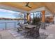 Covered patio with wooden ceiling, dining area, and panoramic views of the lake at 180 Willow Point Rd, Troutman, NC 28166