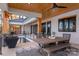 Covered outdoor patio featuring wood columns, dining area, and scenic lake views at 180 Willow Point Rd, Troutman, NC 28166