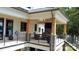 Outdoor porch with beautiful wood columns with a built in fireplace and views of the lake at 180 Willow Point Rd, Troutman, NC 28166