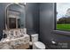 Stylish powder room with a marble countertop sink and dark grey walls at 180 Willow Point Rd, Troutman, NC 28166