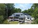 Expansive two-story home with multiple balconies, outdoor living spaces, and picturesque views of the surrounding greenery at 180 Willow Point Rd, Troutman, NC 28166