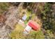 Aerial view of a charming home with a red roof and two metal garages surrounded by lush greenery at 1888 Usher Rd, Lancaster, SC 29720