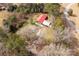 A serene aerial view of a red-roofed house with metal garages, set amidst a canopy of trees and foliage at 1888 Usher Rd, Lancaster, SC 29720