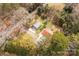 Overhead shot of a quaint home nestled among trees, featuring a red roof and two metal outbuildings at 1888 Usher Rd, Lancaster, SC 29720