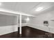 Finished basement with dark hardwood flooring, paneled walls and ample lighting at 1888 Usher Rd, Lancaster, SC 29720