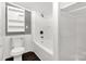 Clean white bathroom with shower-tub combo, toilet, and convenient shelving at 1888 Usher Rd, Lancaster, SC 29720