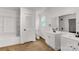 Bright bathroom featuring dual sink vanity, wood floors, and white tile at 1888 Usher Rd, Lancaster, SC 29720