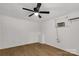 Clean bedroom with wood-look floors, ceiling fan and mini window AC at 1888 Usher Rd, Lancaster, SC 29720