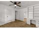 Bedroom features wood floors, ceiling fan, and a built-in desk and shelving system at 1888 Usher Rd, Lancaster, SC 29720