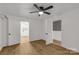 Bright bedroom features wood floors, ceiling fan, and white trim and leads to the kitchen and another room at 1888 Usher Rd, Lancaster, SC 29720