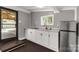 Cozy kitchen features gray walls, white cabinets, and a stainless steel refrigerator at 1888 Usher Rd, Lancaster, SC 29720