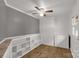Room offers wood floors, grey wainscoting, a ceiling fan, a window view of the outdoors, and shelving at 1888 Usher Rd, Lancaster, SC 29720