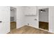 Room boasts wood floors, white walls, and built-in shelving with views into two additional rooms at 1888 Usher Rd, Lancaster, SC 29720
