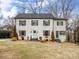 Charming two-story home with a symmetrical facade, a well-manicured lawn, and mature trees in the background at 199 Ingleside Se Dr, Concord, NC 28025