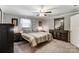 Cozy main bedroom featuring a ceiling fan, comfortable bed, and ample closet space at 211 Spring St, Belmont, NC 28012