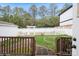 Backyard features a white picket fence, pergola, and well-maintained lawn at 2125 Shenandoah Ave, Charlotte, NC 28205