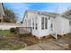Exterior view showcasing the deck, sunroom, and landscaped yard of the home at 2125 Shenandoah Ave, Charlotte, NC 28205