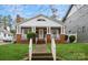 Charming brick home featuring a welcoming front porch with white columns and well-maintained landscaping at 2125 Shenandoah Ave, Charlotte, NC 28205
