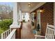 Comfortable front porch with rocking chairs and potted plants, a welcoming entrance to this cozy home at 2125 Shenandoah Ave, Charlotte, NC 28205