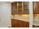 Close up of the kitchen cabinetry featuring granite countertop and glass displays at 2125 Shenandoah Ave, Charlotte, NC 28205