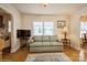 Cozy living room featuring hardwood floors, a striped sofa, and ample natural light at 2125 Shenandoah Ave, Charlotte, NC 28205