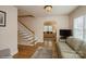 Spacious living room with hardwood floors, a staircase, and an inviting view to the back at 2125 Shenandoah Ave, Charlotte, NC 28205