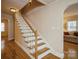 Hardwood staircase with white railings, leading to the upper level of this well-maintained home at 2125 Shenandoah Ave, Charlotte, NC 28205