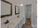 Bathroom featuring double sinks, quartz countertops, framed mirrors and a separate toilet room at 26017 Misty Way Dr, Fort Mill, SC 29708