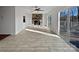 Open-concept living room with a stone fireplace and sliding glass doors leading to a private deck at 26017 Misty Way Dr, Fort Mill, SC 29708