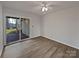 Living room with laminate flooring, fan, and a sliding glass door to a patio at 26017 Misty Way Dr, Fort Mill, SC 29708