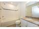 White tiled bathroom with granite countertops, a combination tub and shower, and mosaic tile accents at 2692 Norman Isle Dr, Denver, NC 28037
