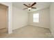 Bright bedroom with neutral carpet, ceiling fan, and a window offering natural light at 2692 Norman Isle Dr, Denver, NC 28037