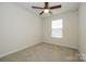Cozy bedroom with carpet flooring, a ceiling fan and a window offering natural light at 2692 Norman Isle Dr, Denver, NC 28037