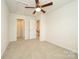 Carpeted bedroom featuring a ceiling fan, multiple closets, and a door leading to the stairs at 2692 Norman Isle Dr, Denver, NC 28037