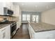 Bright kitchen featuring stainless steel appliances, granite counters, and hardwood floors at 2692 Norman Isle Dr, Denver, NC 28037