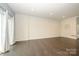 Open living room showcasing hardwood floors and a modern, neutral color palette at 2692 Norman Isle Dr, Denver, NC 28037