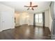 Bright living room with hardwood floors, a ceiling fan, and seamless flow to the entryway at 2692 Norman Isle Dr, Denver, NC 28037