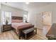 Comfortable main bedroom featuring a wood-frame bed, matching nightstands, a window, and a door to the ensuite at 293 Blanche Cir, Rock Hill, SC 29730