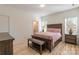 Cozy main bedroom showcasing a wood-frame bed, matching nightstands, and an adjacent bathroom at 293 Blanche Cir, Rock Hill, SC 29730