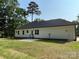 Backyard featuring an expansive lawn, concrete patio, and ample natural light at 309 General As Johnston St, Stanley, NC 28164