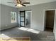 Bedroom featuring large window and barn door to bathroom at 309 General As Johnston St, Stanley, NC 28164