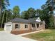 Beautiful single-Gathering home with a two-car garage, brick facade, and fresh landscaping at 309 General As Johnston St, Stanley, NC 28164