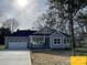 New home with gray siding, white trim, a two-car garage, and freshly laid lawn at 309 General As Johnston St, Stanley, NC 28164