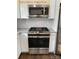 Kitchen features stainless appliances, granite countertop, and white cabinets at 309 General As Johnston St, Stanley, NC 28164