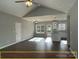 An open-concept living room flows into a modern kitchen, highlighted by hardwood floors and natural light at 309 General As Johnston St, Stanley, NC 28164